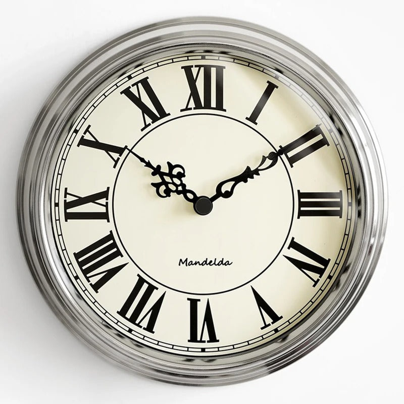 This Roman Numerals Wall Clock adds a tailored balance of function and visual interest to home decor.